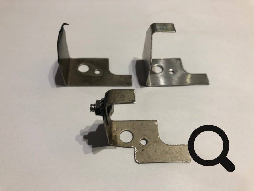 Set of three Netaheat earth brackets - old, new and repaired